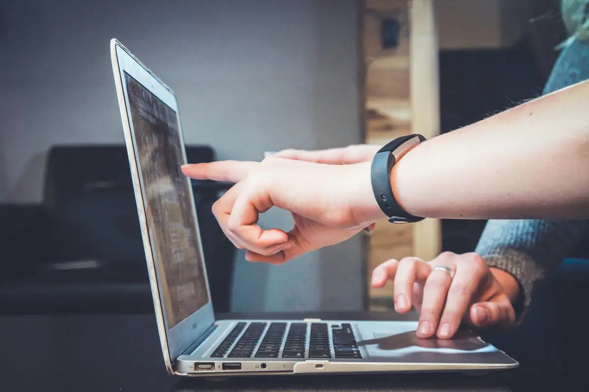 A group of students sitting in a classroom and participating in an interactive and engaging learning experience that has been enhanced through the use of AI and IoT technology.