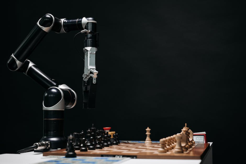 An image showing a robotic arm inside a factory, representing the impact of AI on job automation and the displacement of human workers.