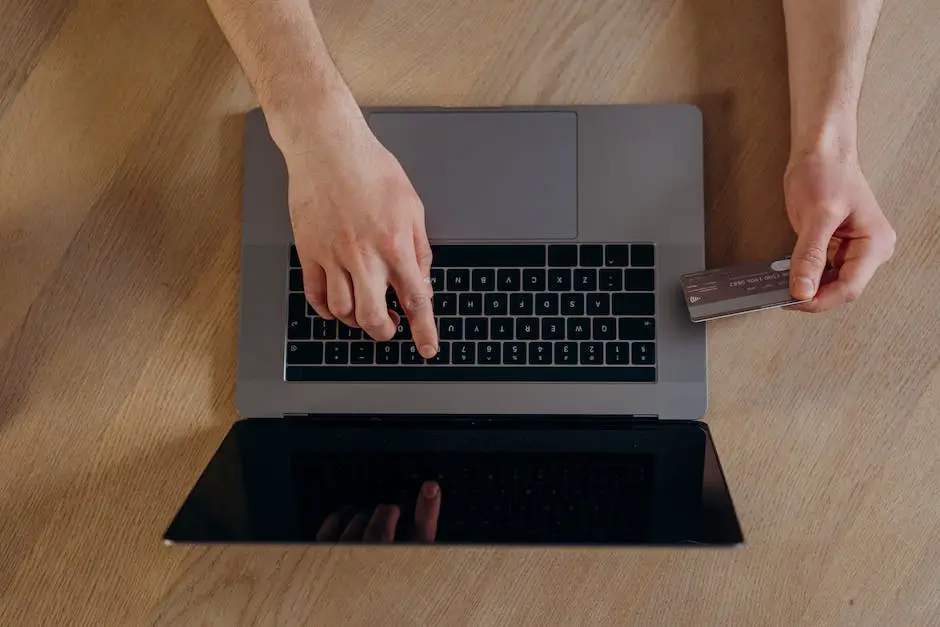 A picture of a hand holding a credit card in front of a screen with code on it, representing deep learning in finance.