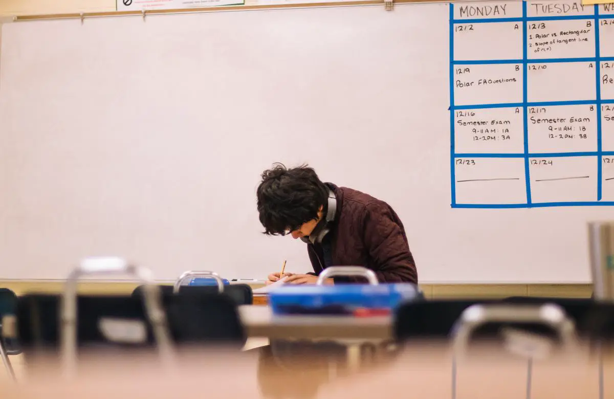 Illustration of a computer-generated student surrounded by personalized study materials, with an AI-powered chatbot in the corner helping the student with their studies.